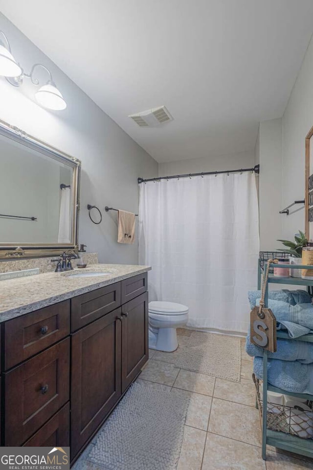 1985 Roscoe Rd, Newnan, GA 30263 - full bathroom with visible vents, vanity, toilet, and tile patterned floors