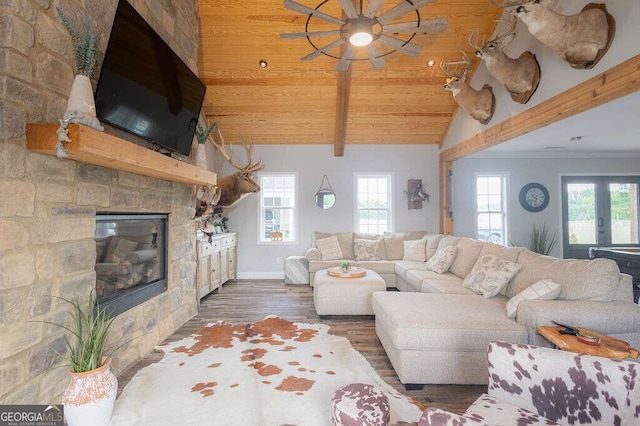 1985 Roscoe Rd, Newnan, GA 30263 - living room with plenty of natural light, vaulted ceiling with beams, a stone fireplace, and wood finished floors