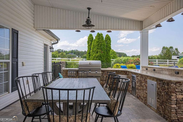 1985 Roscoe Rd, Newnan, GA 30263 - view of patio with area for grilling, a grill, fence, outdoor wet bar, and outdoor dining space