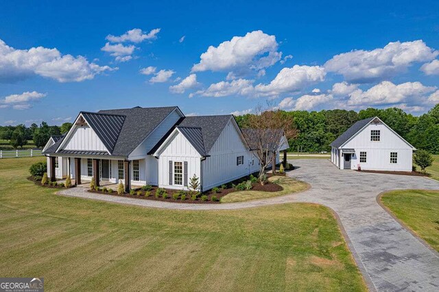 1985 Roscoe Rd, Newnan, GA 30263 - modern farmhouse with aphalt driveway, a standing seam roof, covered porch, board and batten siding, and a front yard