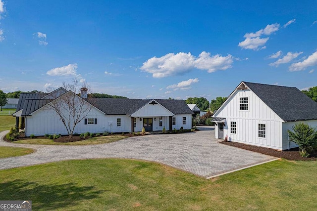 1985 Roscoe Rd, Newnan, GA 30263 - view of front facade featuring decorative driveway, a front lawn, board and batten siding, and roof with shingles