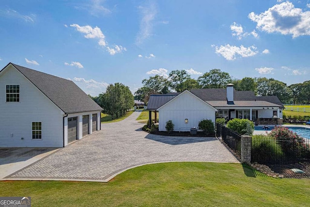 1985 Roscoe Rd, Newnan, GA 30263 - view of front of property with a fenced in pool, decorative driveway, a chimney, a front yard, and a garage