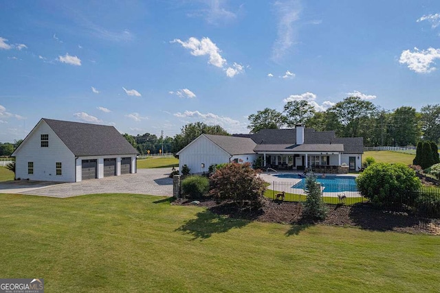 1985 Roscoe Rd, Newnan, GA 30263 - back of property with a garage, driveway, a fenced in pool, a chimney, and a yard