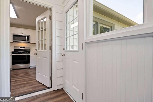 doorway with dark hardwood / wood-style floors