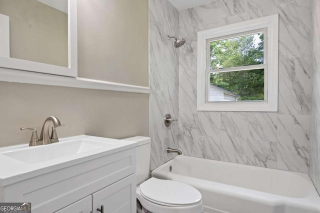 full bathroom featuring vanity, tiled shower / bath combo, and toilet