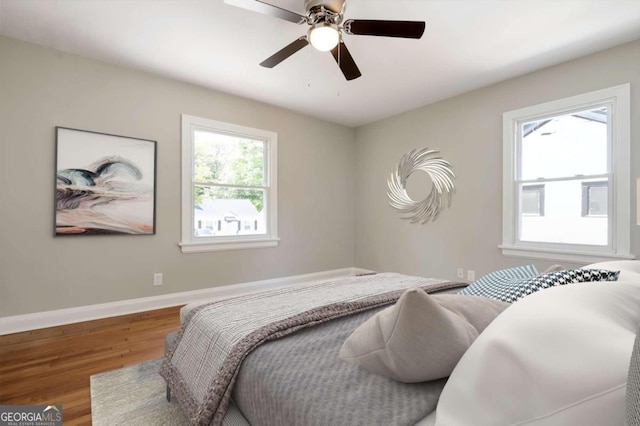 bedroom with hardwood / wood-style floors and ceiling fan