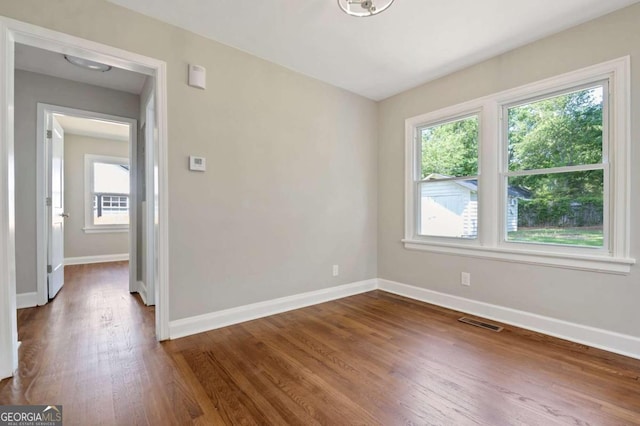 empty room featuring dark hardwood / wood-style flooring