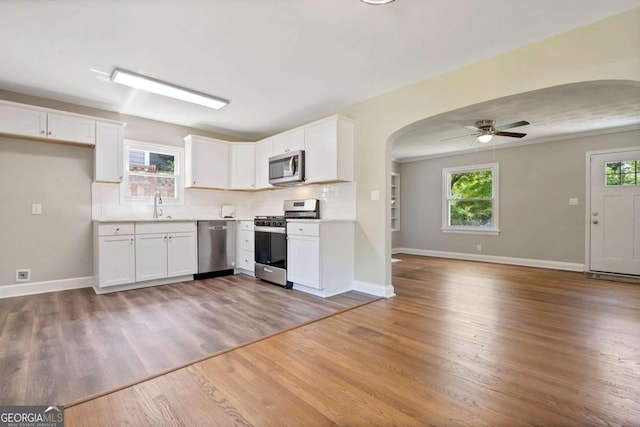 kitchen with plenty of natural light, white cabinetry, and appliances with stainless steel finishes