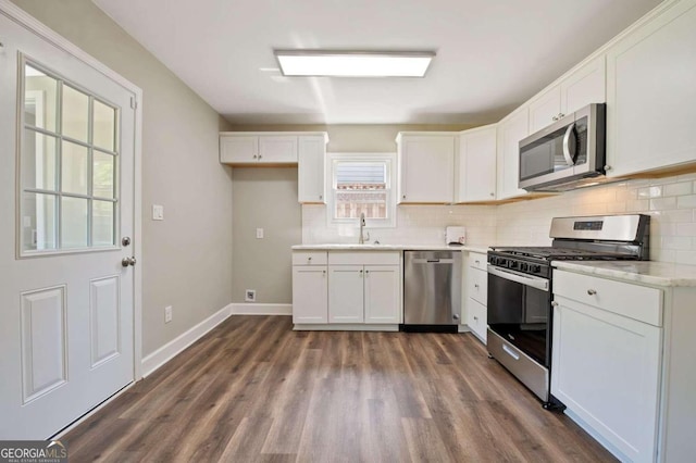 kitchen featuring sink, white cabinets, stainless steel appliances, and dark hardwood / wood-style floors