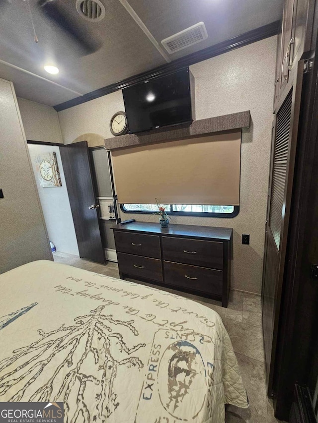 bedroom with ceiling fan and tile patterned floors