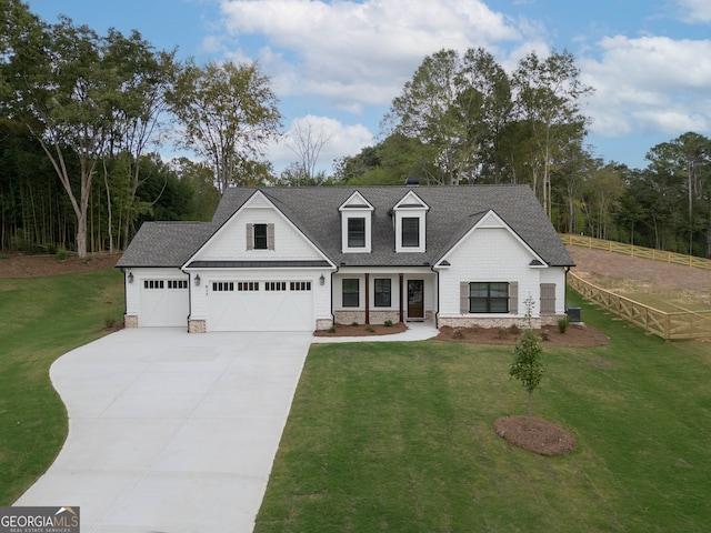 view of front of property featuring a garage and a front lawn