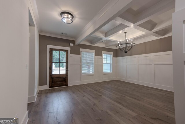 entryway featuring coffered ceiling, dark wood-type flooring, beamed ceiling, crown molding, and an inviting chandelier