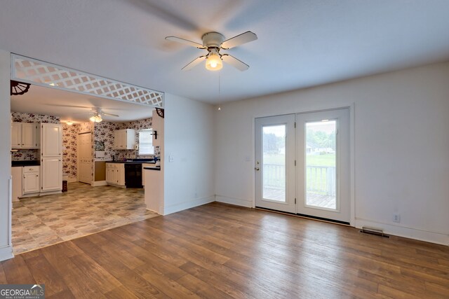 unfurnished living room with light wood-type flooring and ceiling fan