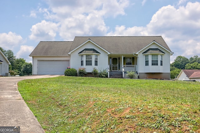 single story home featuring covered porch, a garage, and a front lawn