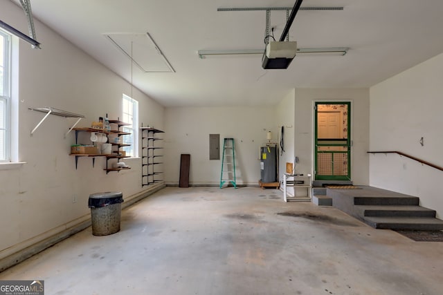 garage with a garage door opener, electric water heater, and electric panel