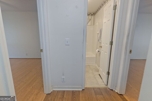 hallway with light hardwood / wood-style flooring