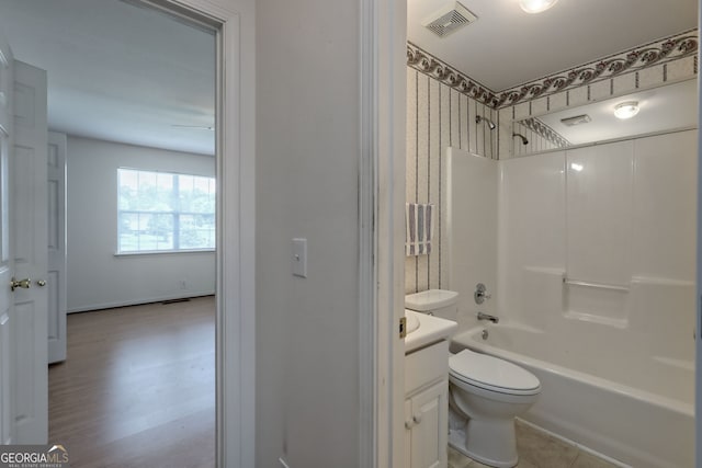 full bathroom featuring  shower combination, vanity, hardwood / wood-style flooring, and toilet