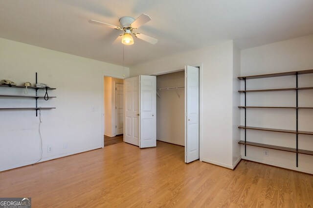 unfurnished bedroom with a closet, light wood-type flooring, and ceiling fan