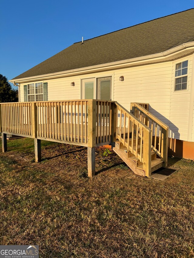 rear view of property featuring a wooden deck