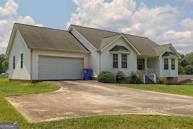 single story home with a front yard and a garage