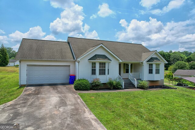 single story home featuring a front lawn and a garage