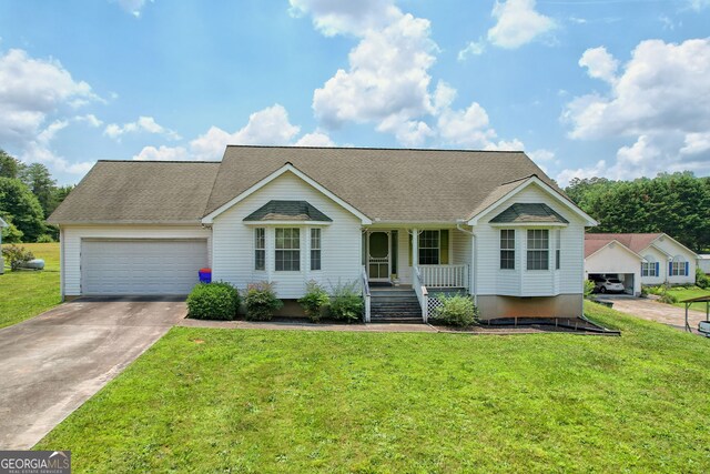 ranch-style house with a front lawn, covered porch, and a garage