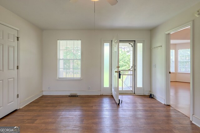 doorway to outside with a wealth of natural light, ceiling fan, and dark hardwood / wood-style flooring