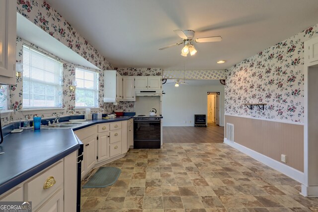 kitchen featuring white cabinetry, black range with electric stovetop, sink, and ceiling fan