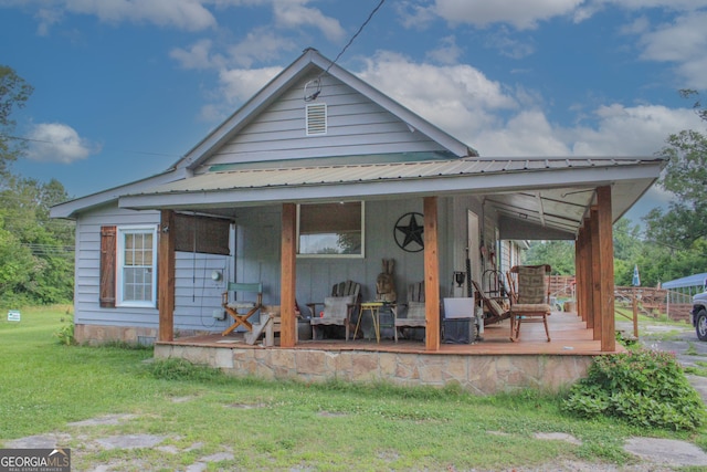 back of house with a lawn