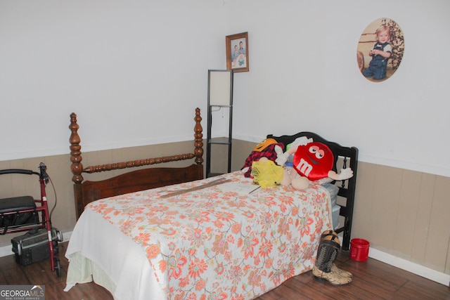 bedroom with dark hardwood / wood-style flooring