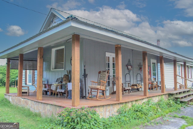 back of property featuring covered porch