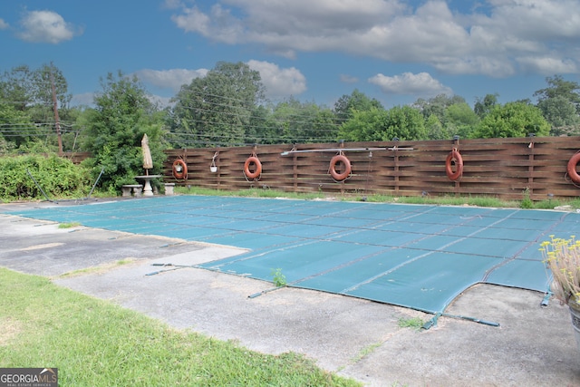 view of swimming pool with a patio