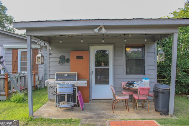 view of patio with an outdoor structure and a grill