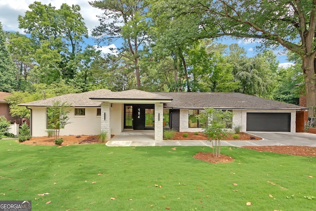 view of front facade with a front lawn and a garage