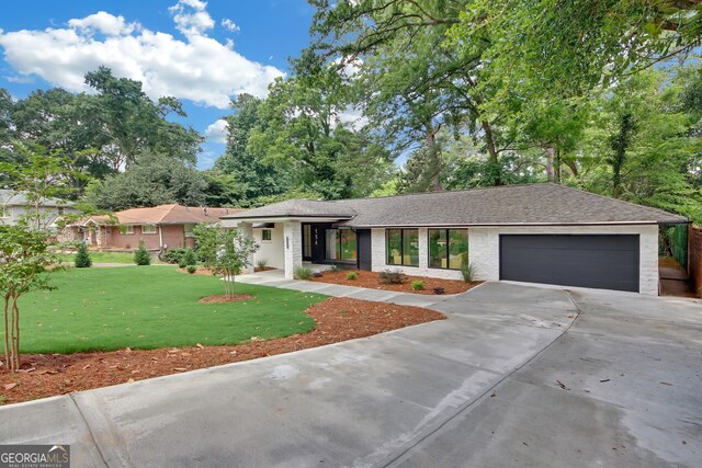 view of front facade with a garage and a front lawn