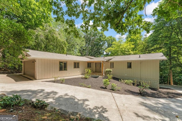 view of front of home with concrete driveway and an attached garage