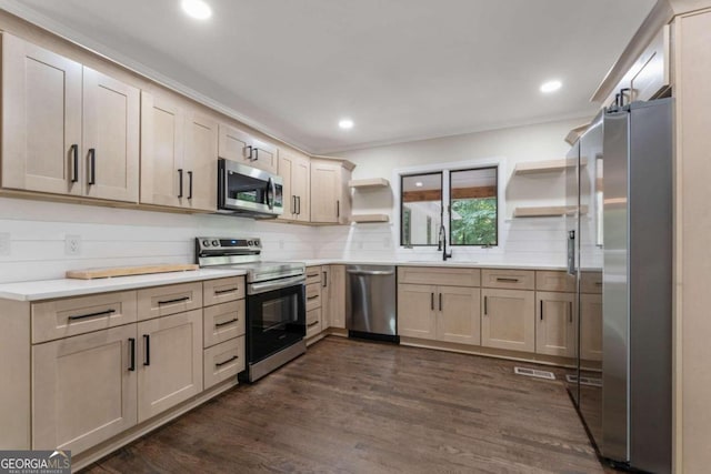 kitchen with dark hardwood / wood-style flooring, stainless steel appliances, backsplash, sink, and light brown cabinetry