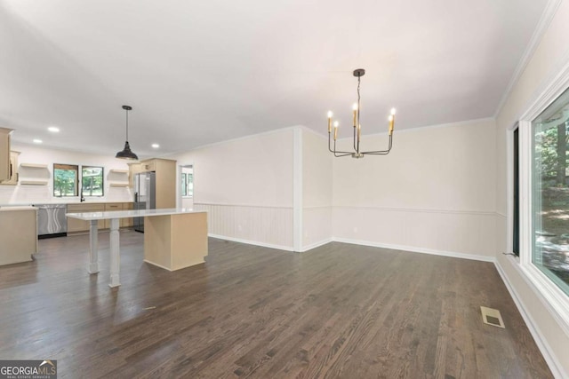 unfurnished living room with a chandelier, ornamental molding, and dark wood-type flooring