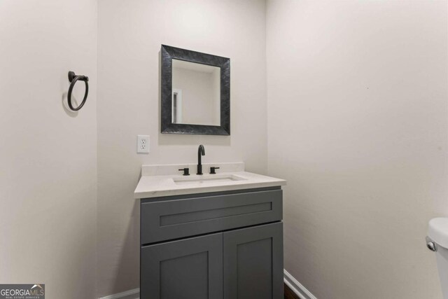 bathroom featuring toilet and vanity