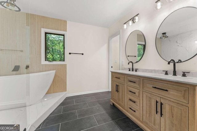 bathroom featuring double vanity, a washtub, and tile flooring