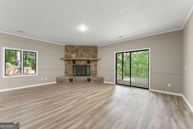 unfurnished living room featuring crown molding, a fireplace, and wood-type flooring