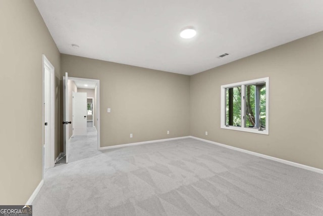 unfurnished bedroom featuring light carpet