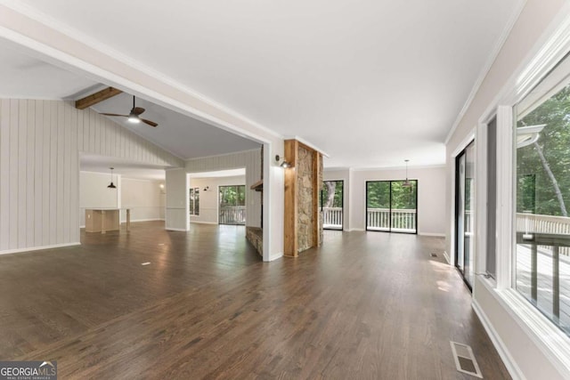 unfurnished living room with crown molding, dark wood-type flooring, ceiling fan, and lofted ceiling with beams