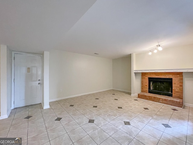 unfurnished living room featuring light tile patterned flooring and a brick fireplace