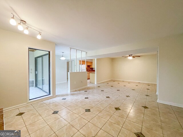 unfurnished room featuring ceiling fan and light tile patterned floors