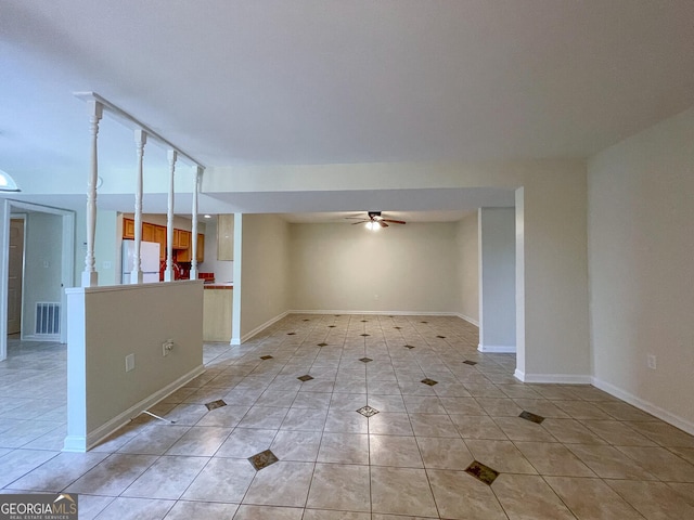 tiled empty room featuring ceiling fan