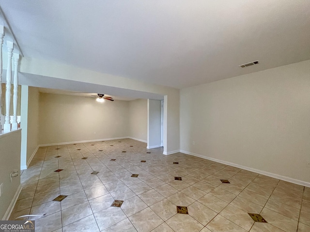 unfurnished room with ceiling fan and light tile patterned floors