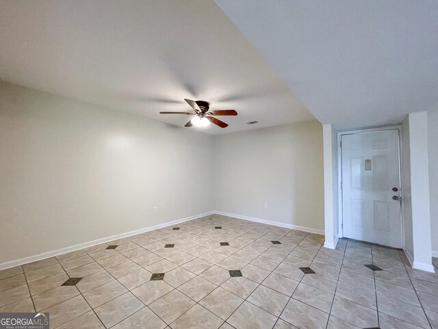 tiled empty room with ceiling fan