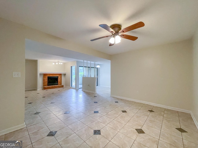 unfurnished living room featuring ceiling fan, light tile patterned floors, and a brick fireplace