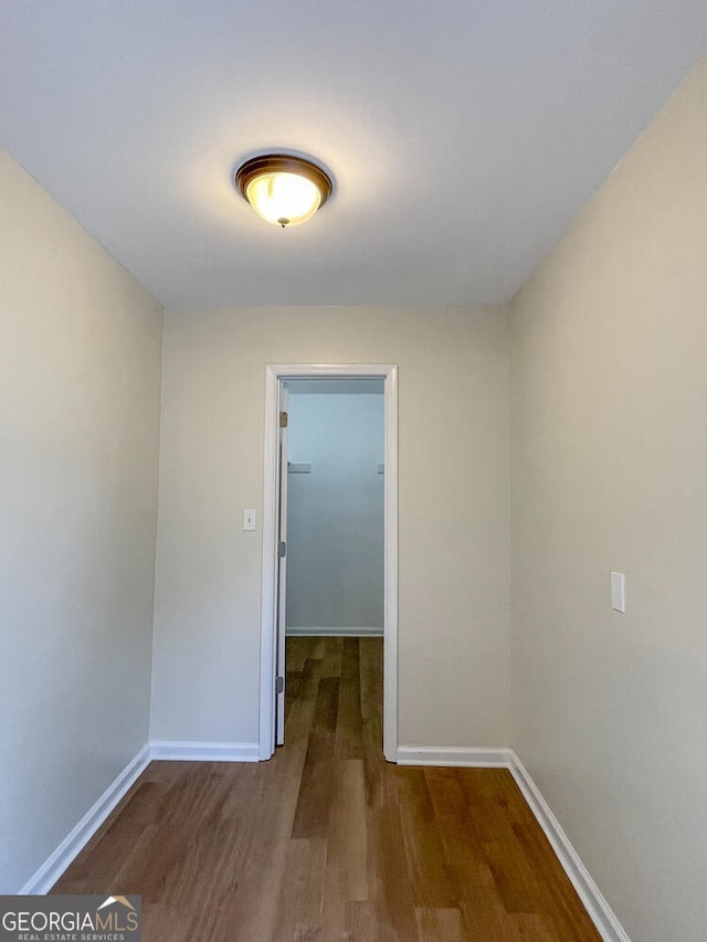 hall with hardwood / wood-style flooring